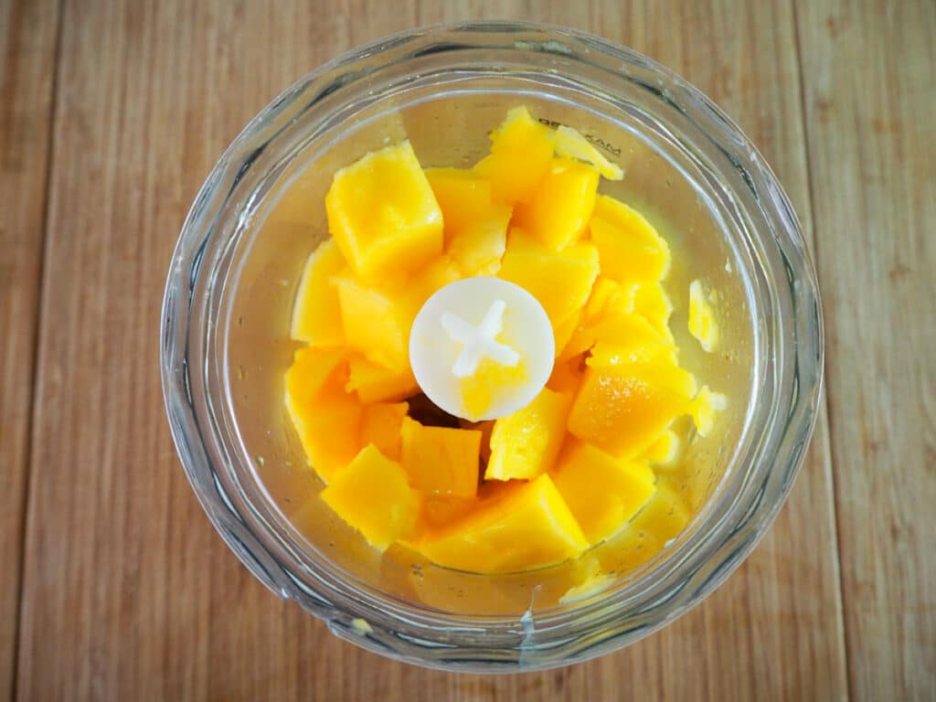 Mango flesh in food processor ready to blitz.