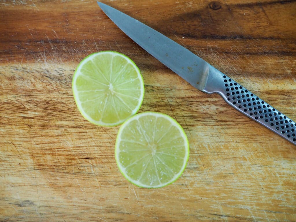 Slicing limes in half to juice.