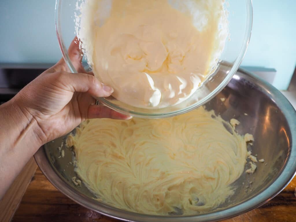Adding whipped cream into rest of cheesecake filling.