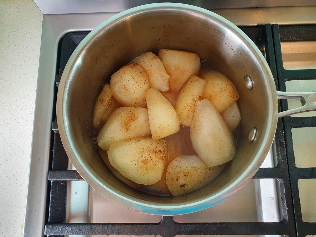 Cooked pears in pot on stove.