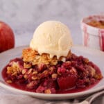 Close up apple and plum crumble with ice cream