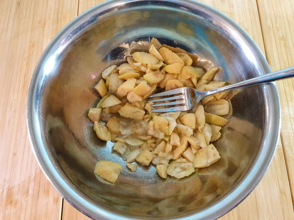 Mashing feijoa flesh with a fork.