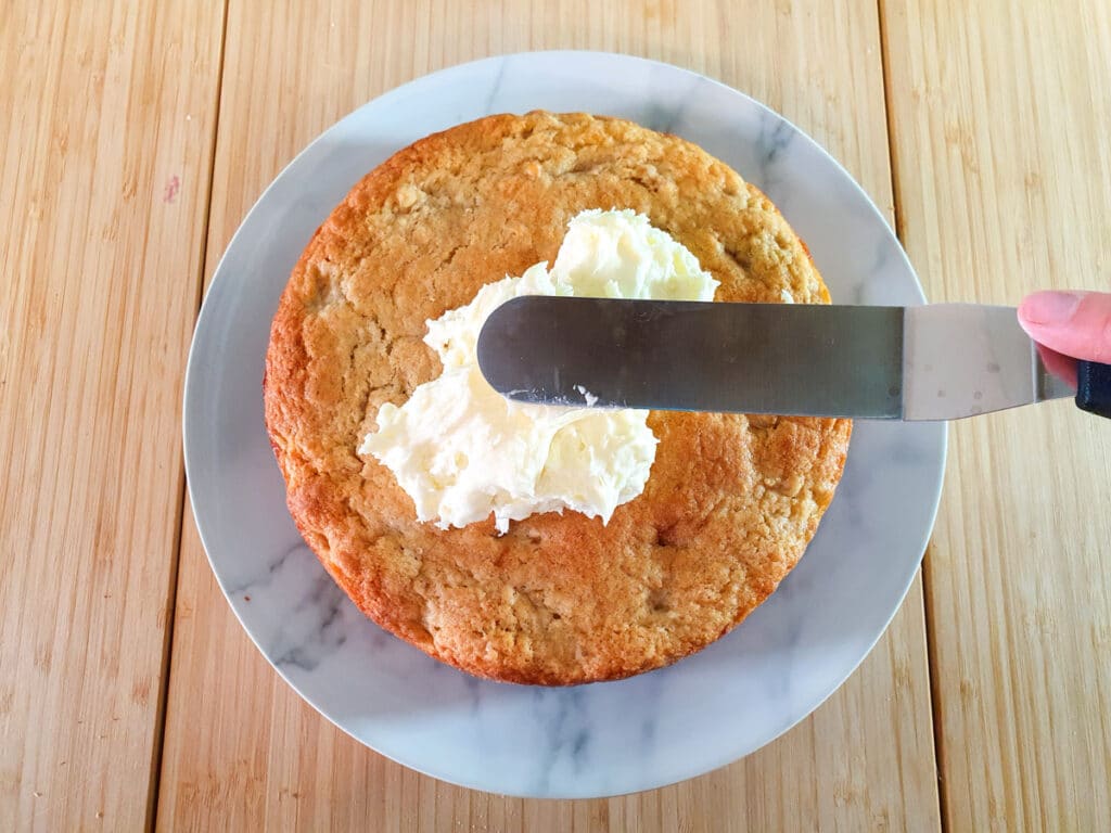 Smoothing down icing with an offset spatula.