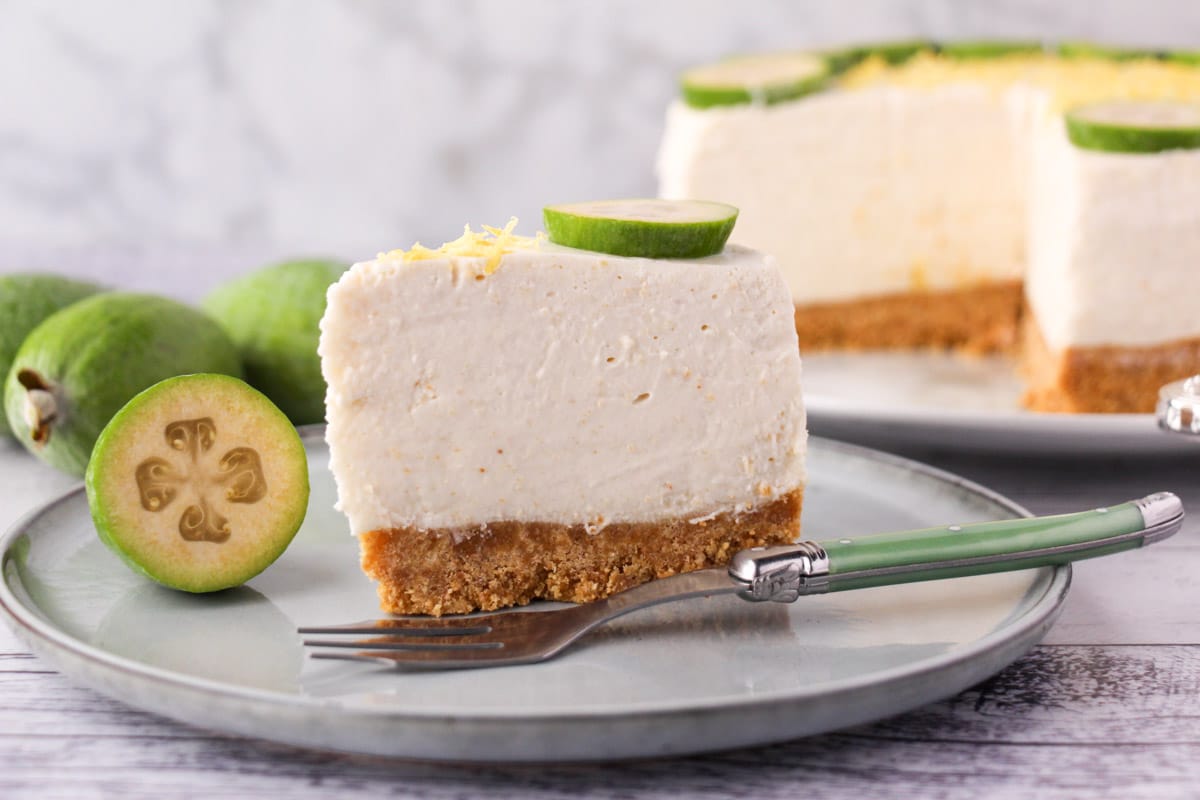 No Bake Cheesecake Recipes 32 Slice of feijoa cake on the serving plate with vintage spoon, rest of cake and fresh feijoas in the background.