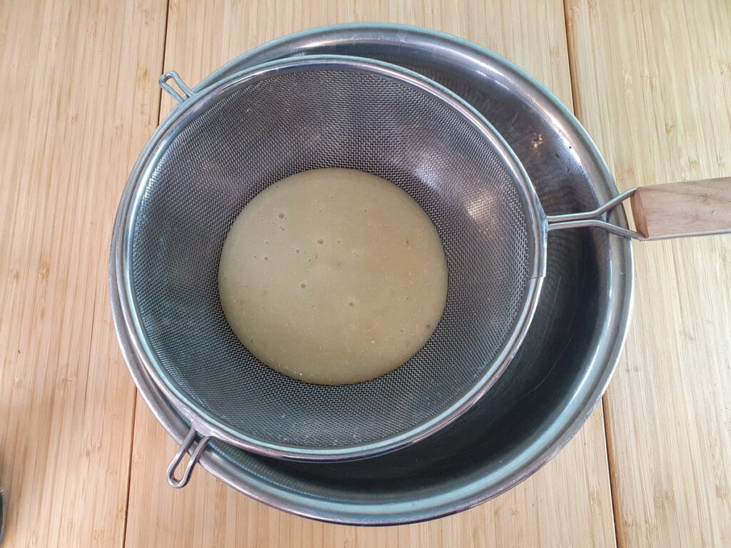 Straining feijoa pulp through a fine sieve.