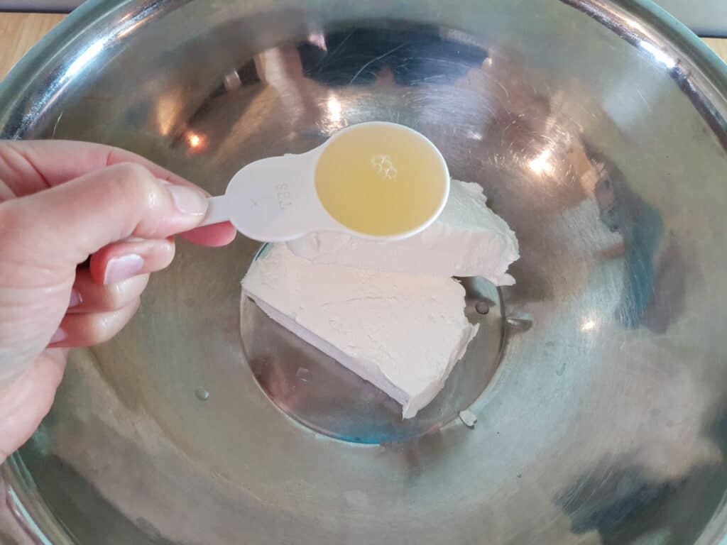 Adding lemon juice to cream cheese.