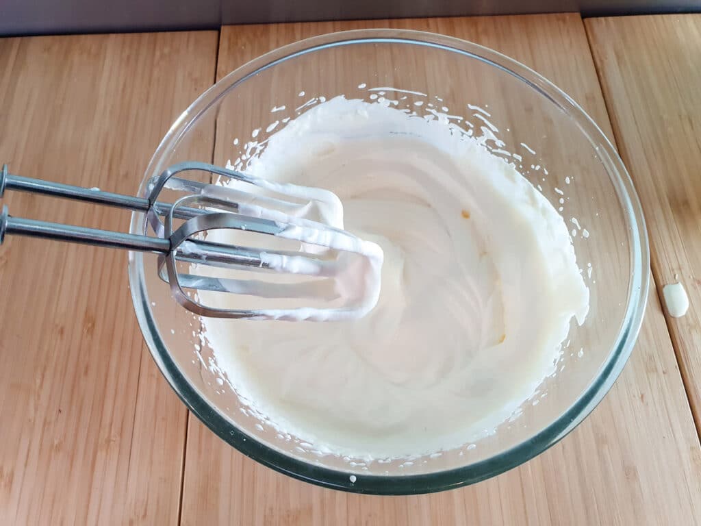 Feijoa cheesecake 17 Whipping cream with an electric hand held beaters.