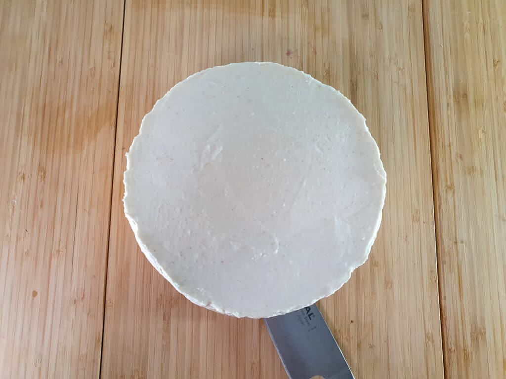 Removing cheesecake from base of tin.