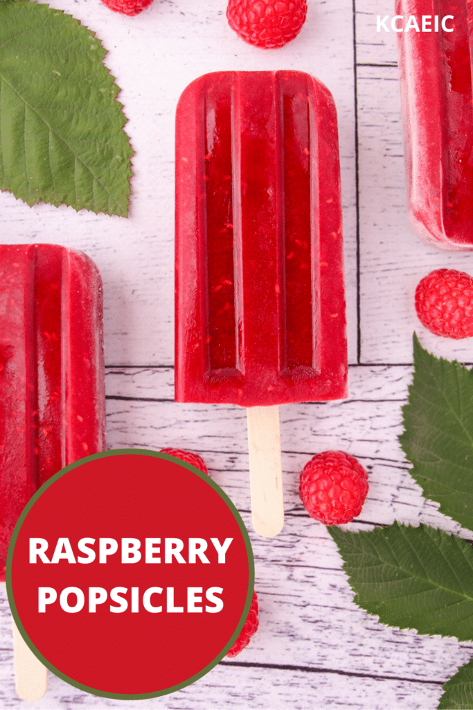 Raspberry popsicles with fresh raspberries and leaves, with text overlay, raspberry popsicles and KCAEIC.