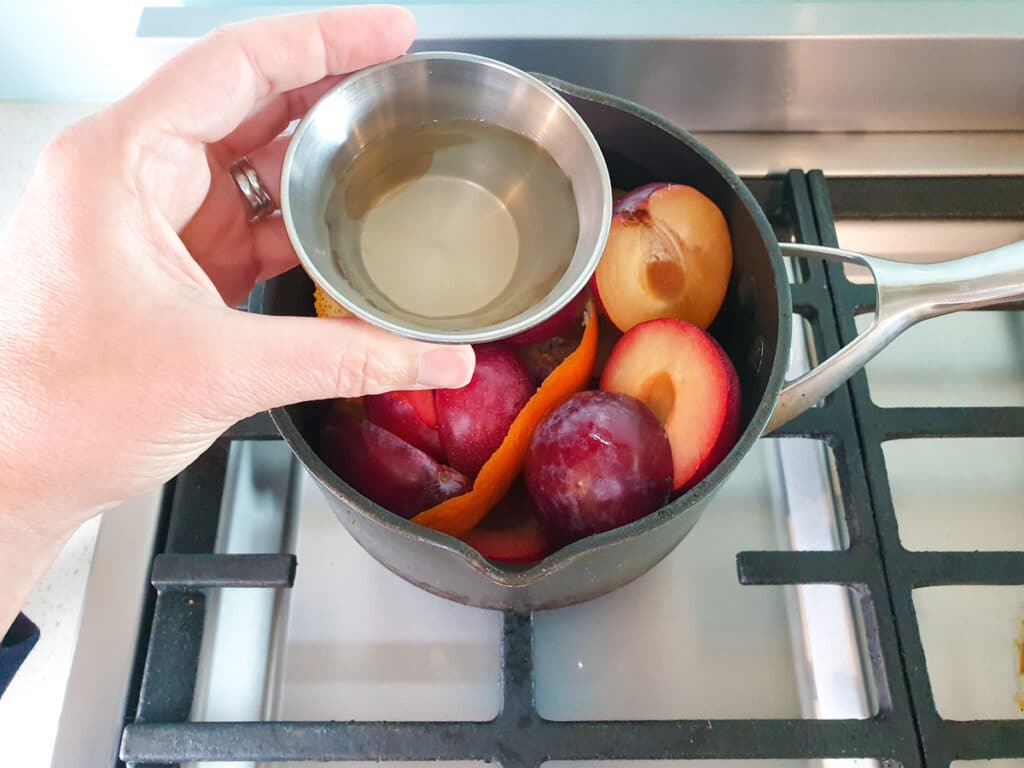 Stewed plums 8 Adding vanilla water to plums.