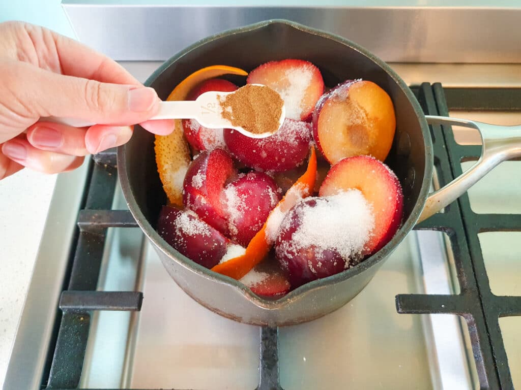 Stewed plums 10 Adding Chinese five spice to plumbs.