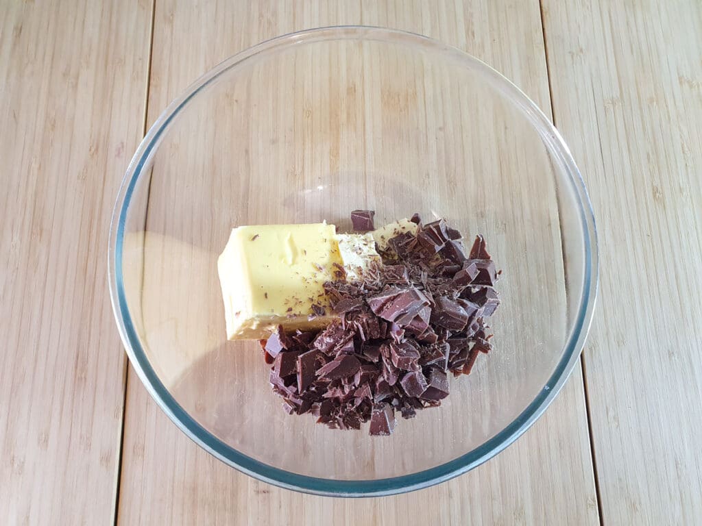 Adding butter and chopped chocolate to a microwave proof bowl.