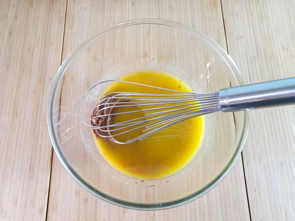 Whisking melted butter and chocolate together.