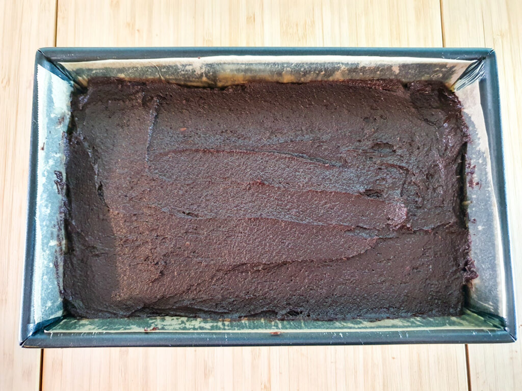 Smoothing batter into lined brownie tin.