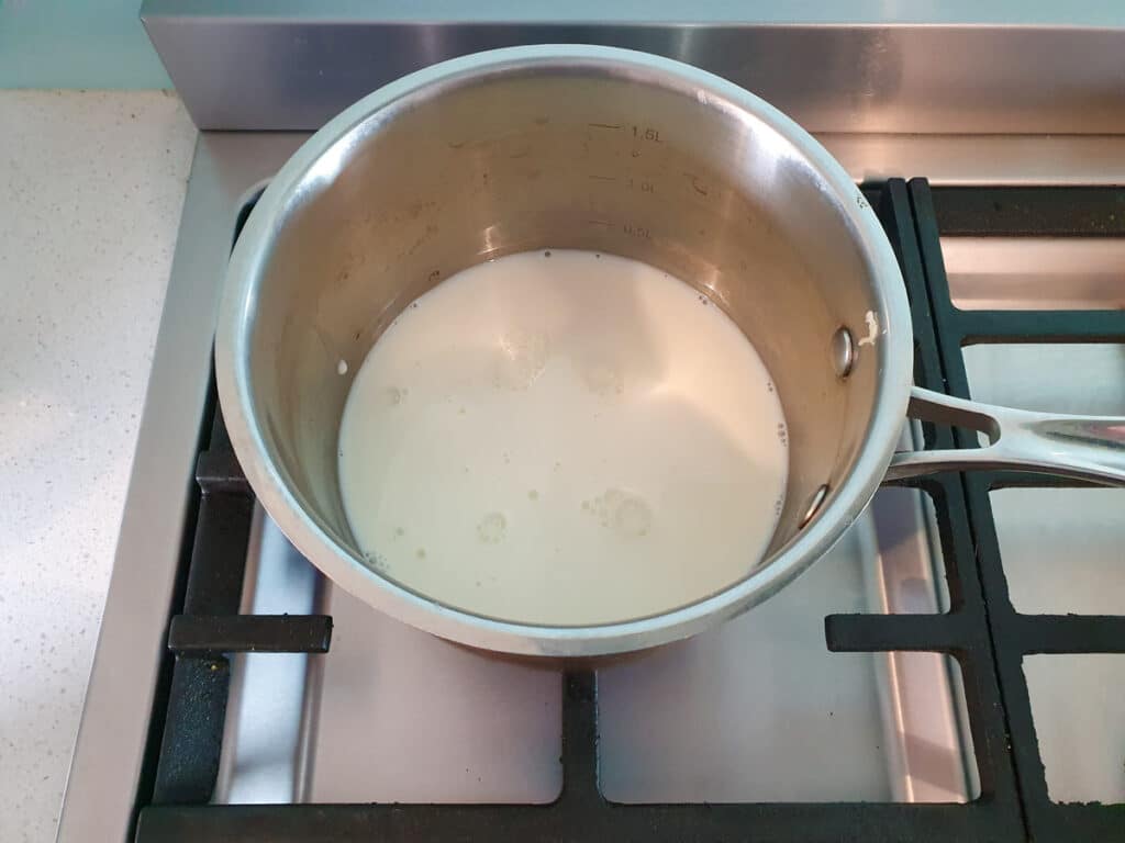 Raspberry ice cream 8 Warming up milk on stove.