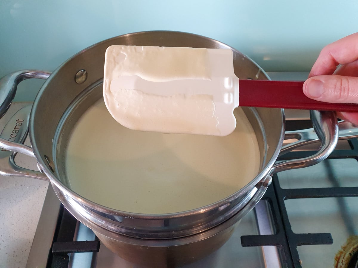 Spatula showing cooked ice cream mix holding the line when a finger is run through it.