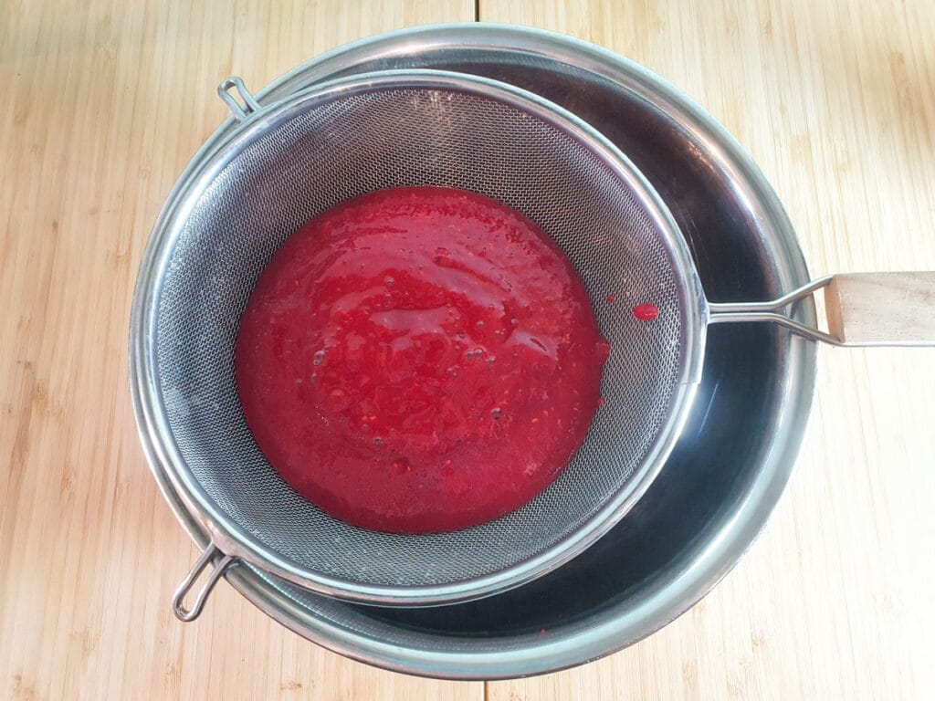 Raspberry ice cream 5 Straining blitzed raspberries.