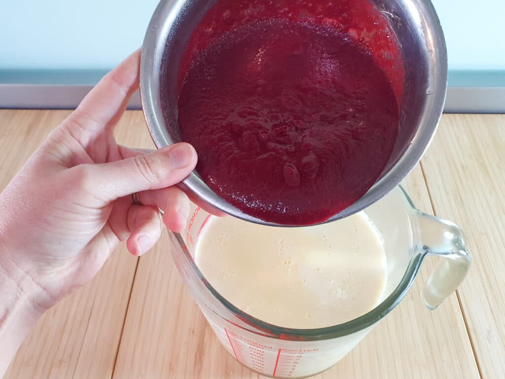 Raspberry ice cream 17 Adding raspberry reduction to rest of chilled ice cream mix.