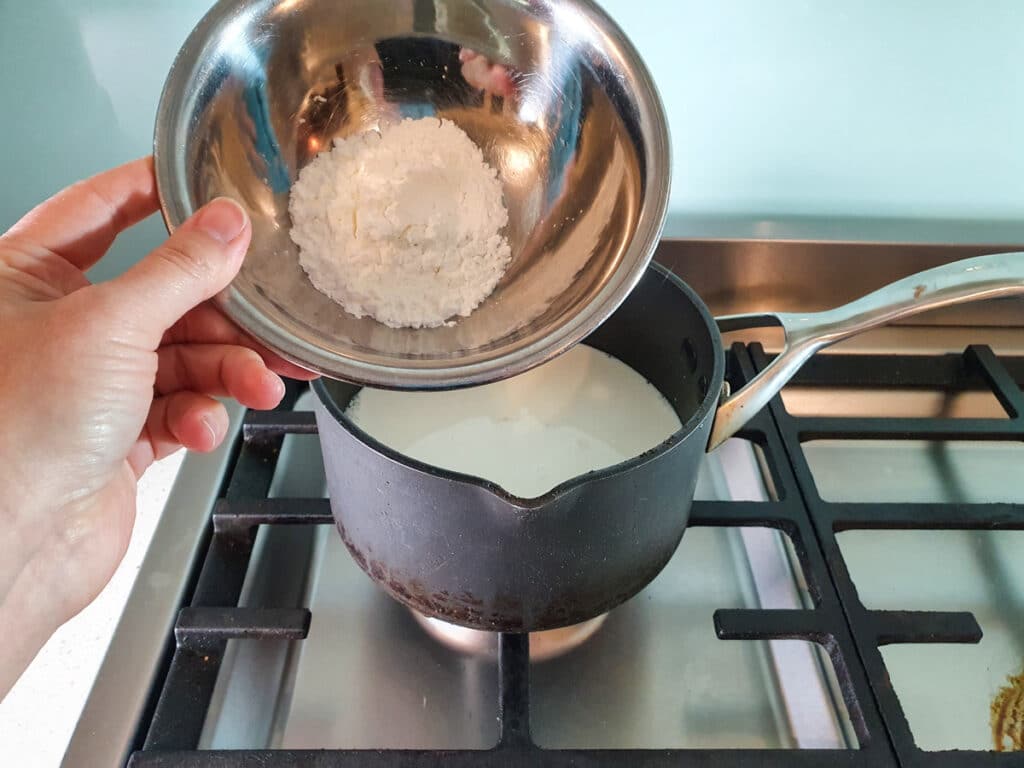 Adding corn flour to pot.