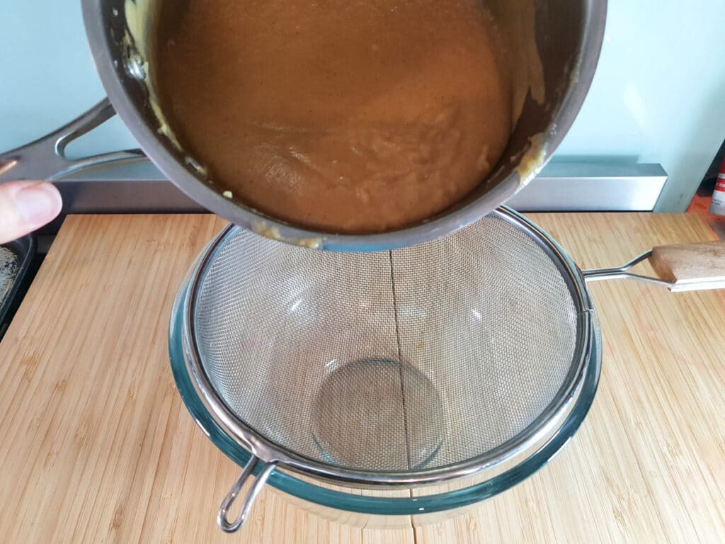 Sieving cooked curd.