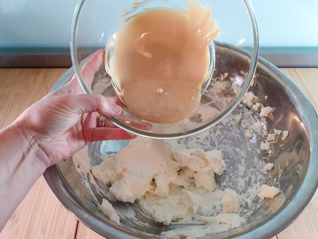 Caramilk cheesecake 13 Adding melted chocolate to cream cheese.