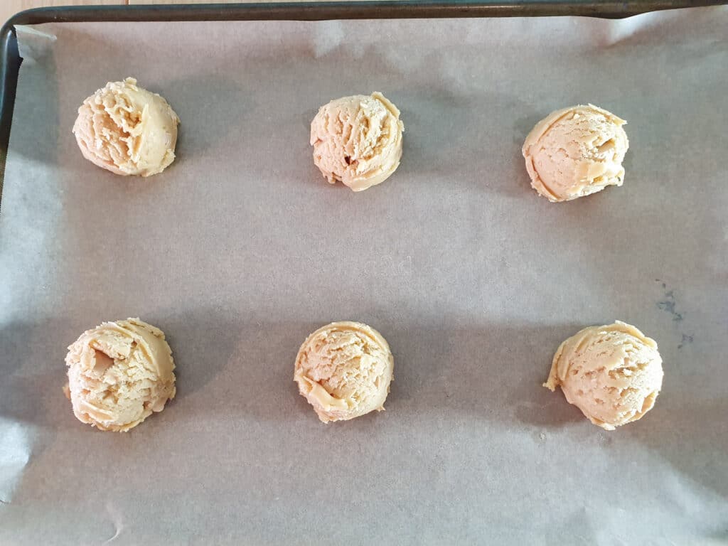 Caramilk cookies 12 Cookies on lined baking tray ready to bake.