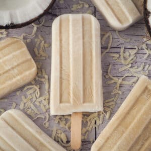 Coconut popsicles 10 Close up coconut popsicles with fresh coconut and shredded coconut.