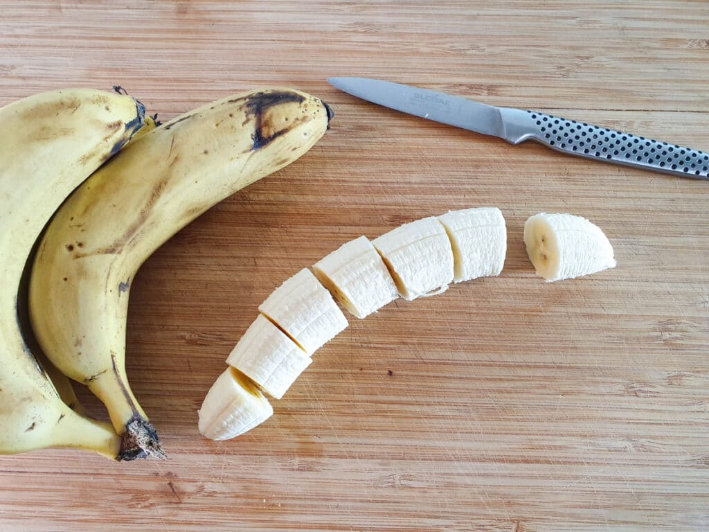 Peeling and slicing bananas into coins.