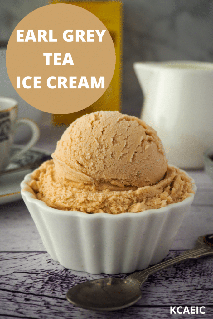 Scoop of earl grey ice cream with spoon, tea cup and milk jug in the background.