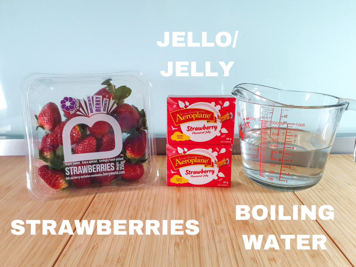 Jello popsicles 3 Ingredients, strawberries, two packets strawberry jello, boiling water.