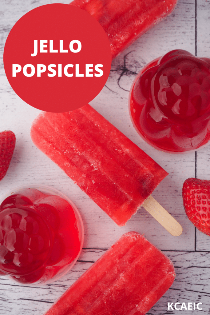 Strawberry jello popsicles with mini molded strawberry jellos, fresh strawberries and text overlay, jello popsicles and KCAEIC.