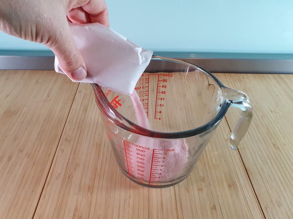 Adding jello to microwave proof jug.