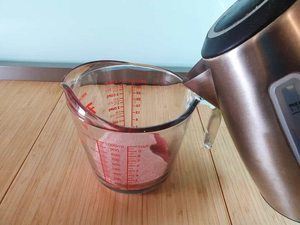 Jello popsicles 5 Adding boiling water to jug.