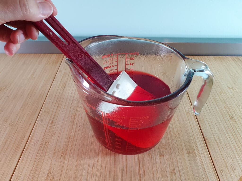 Stirring jello mix well to dissolve all the jello.
