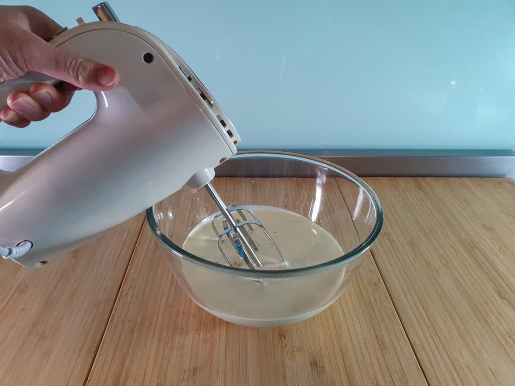 Whipping cream with hand held electric mixer.