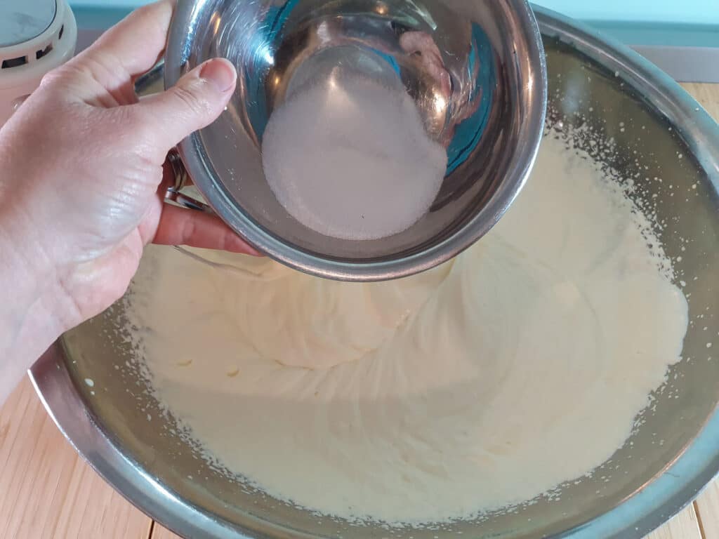 Adding sugar to cream.
