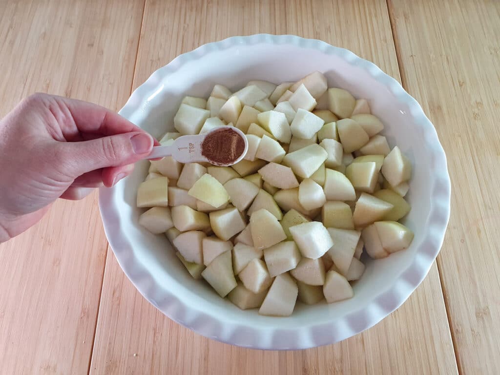 Pear crumble 6 Adding cinnamon to pears.