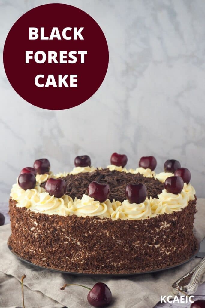 Cake with fresh cherries and silver serving utensils, with text overlay, black forest cake and KCAEIC.