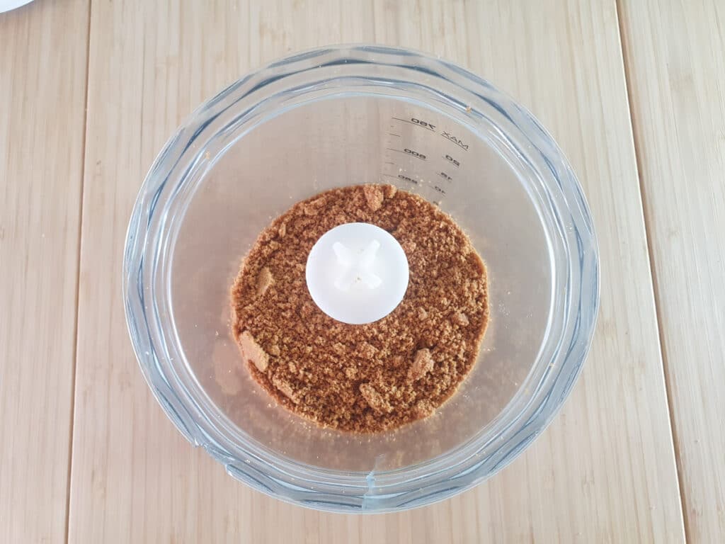 Processing biscuits into crumbs in food processor.
