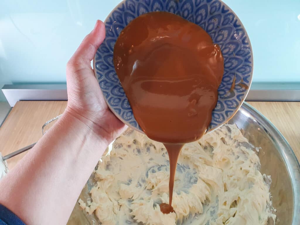 Adding melted biscoff spread to cream cheese and lemon mix.