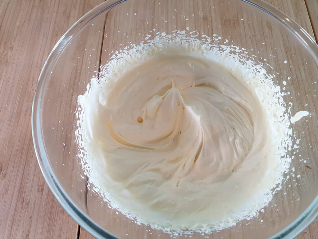 Whipping cream into soft peaks.