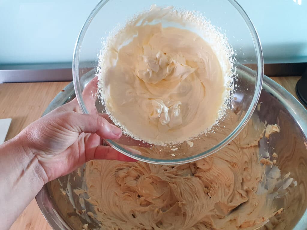 Adding whipped cream to cream cheese mix.