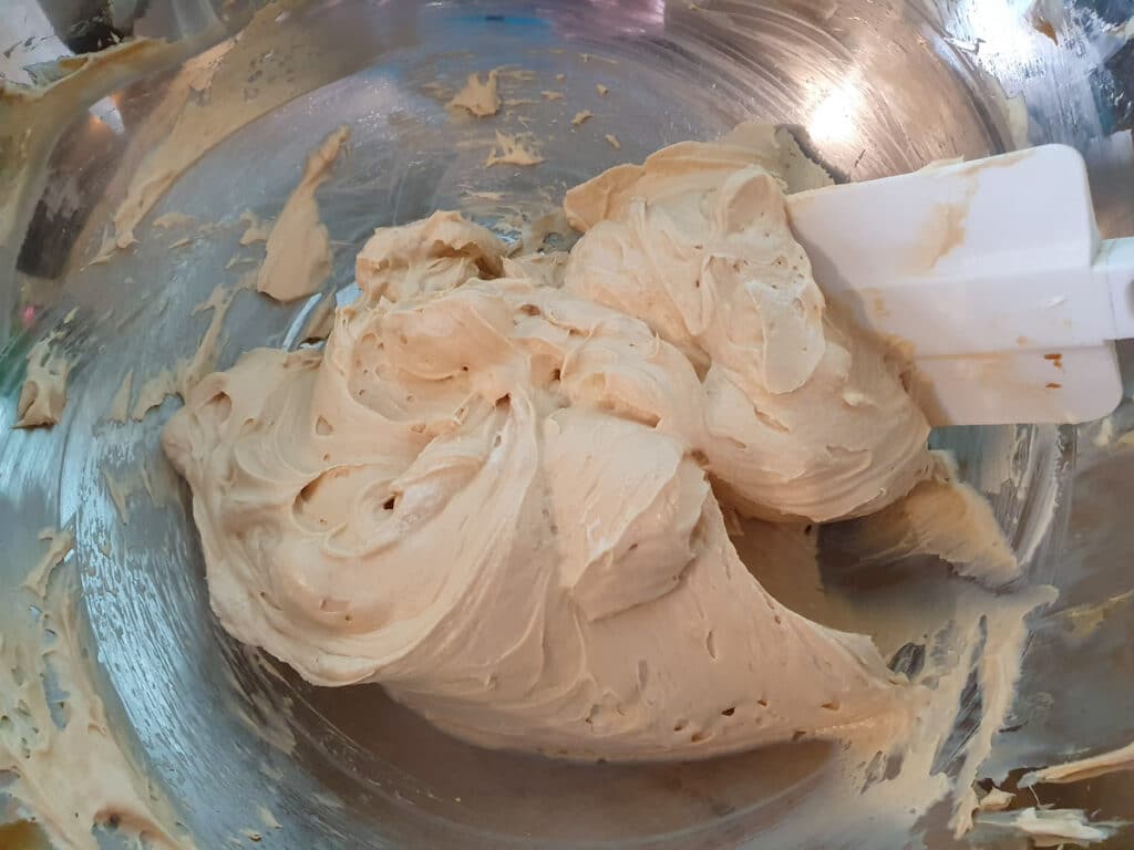 Folding whipped cream into cream cheese mix.