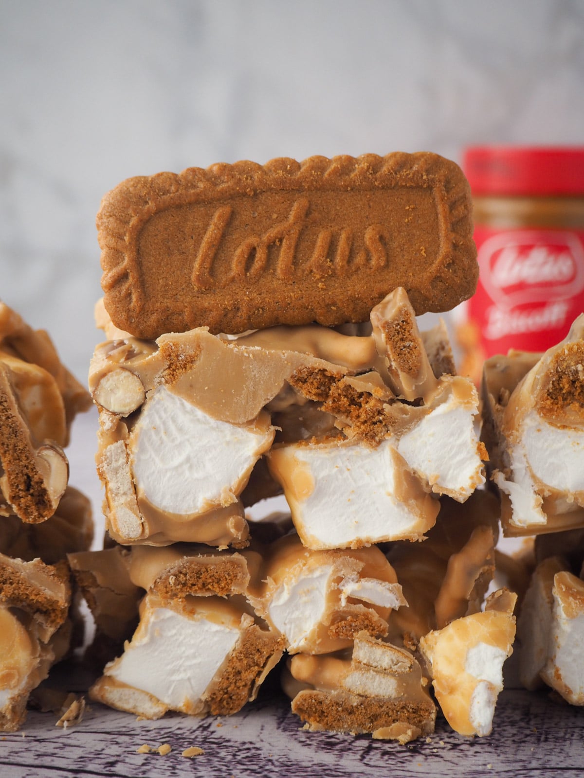 Close up rocky road with Biscoff jar in the background.