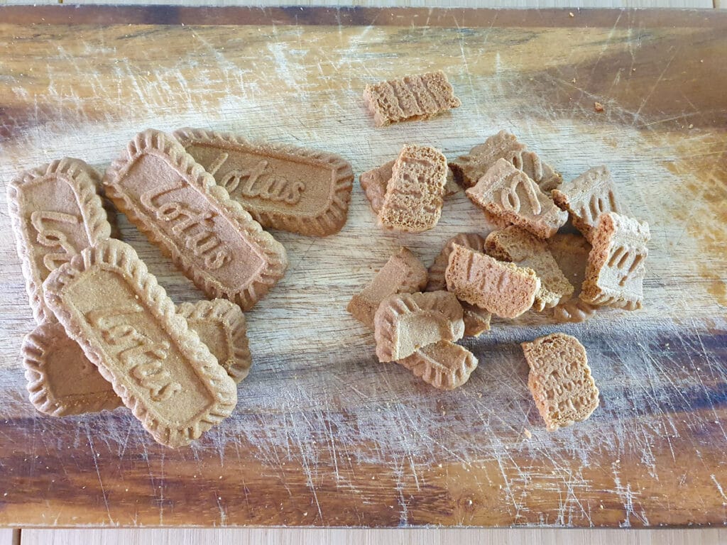 Breaking up biscuits into pieces.