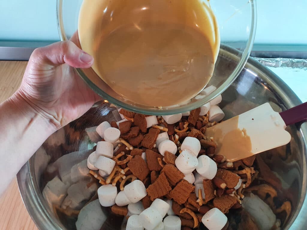 Add melted white chocolate and biscoff spread to dry ingredients.