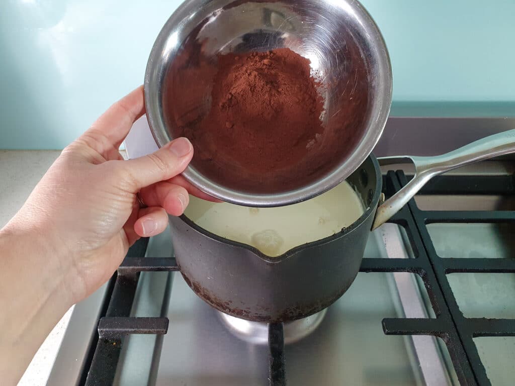Adding Dutch cocoa powder to ice cream mix.