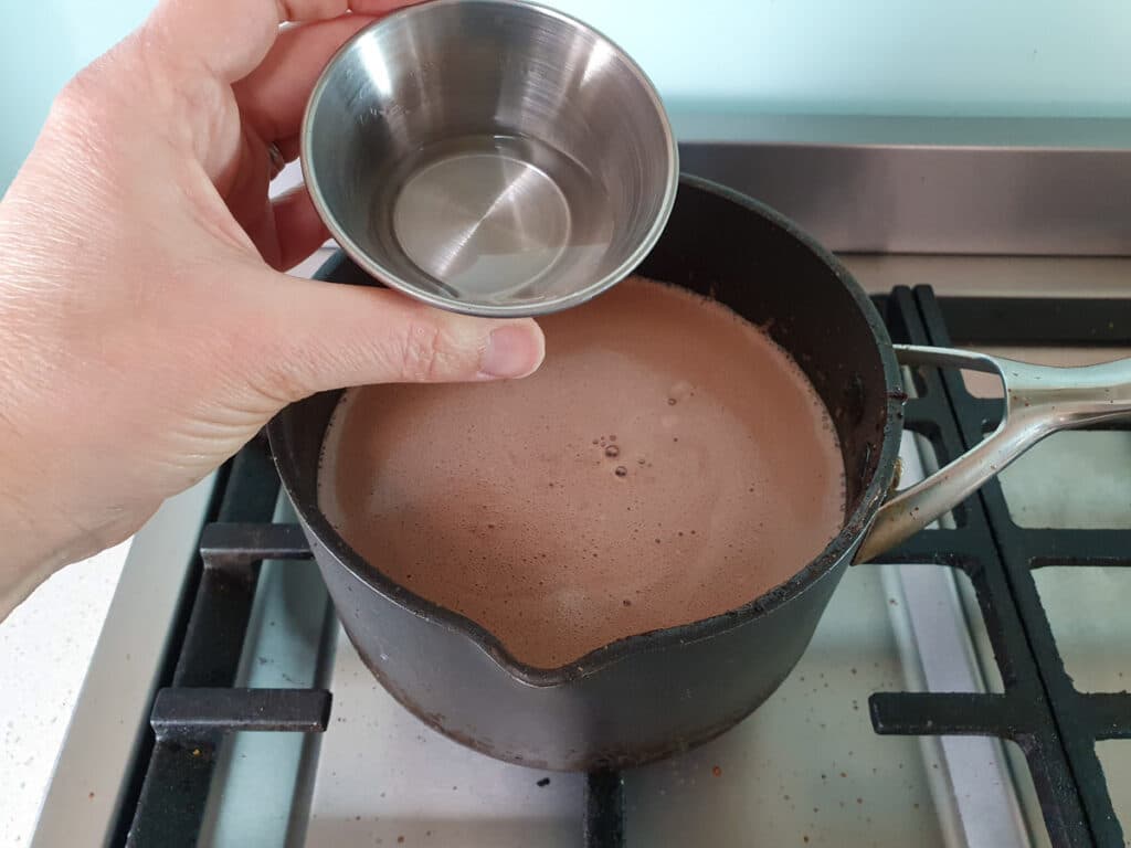 Adding kirsch to ice cream mix.