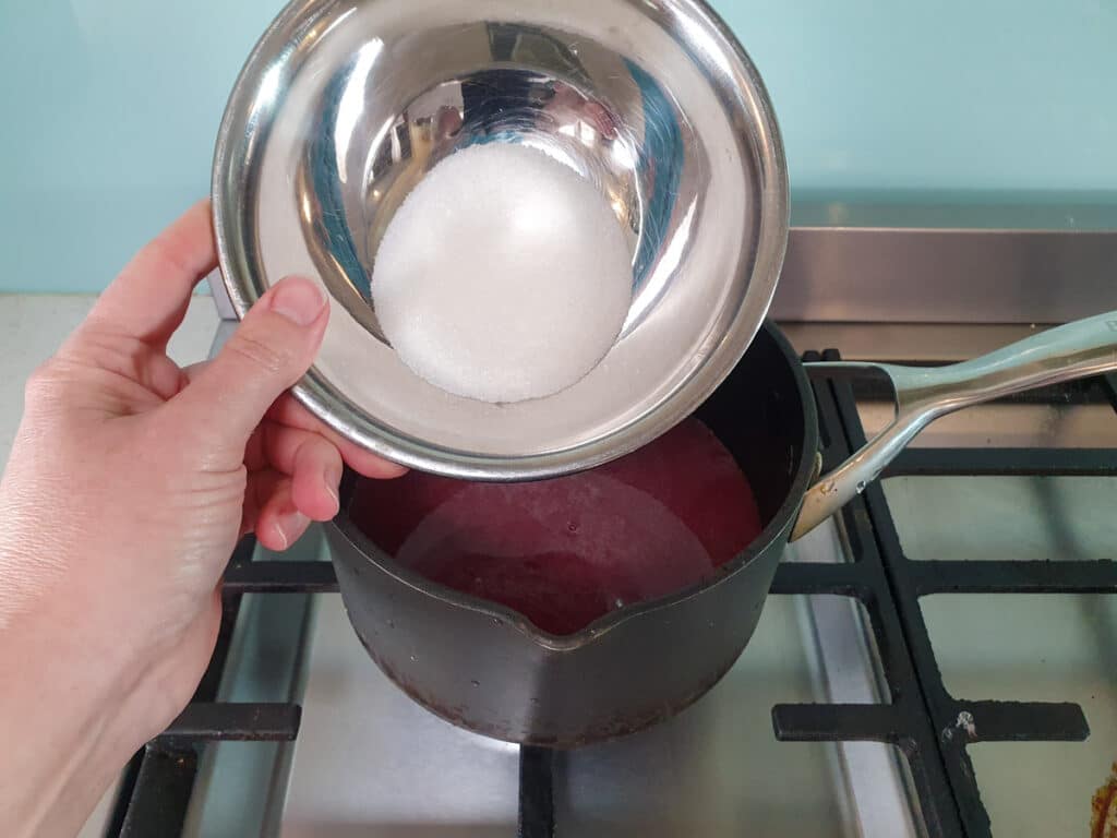 Adding sugar to cherries.