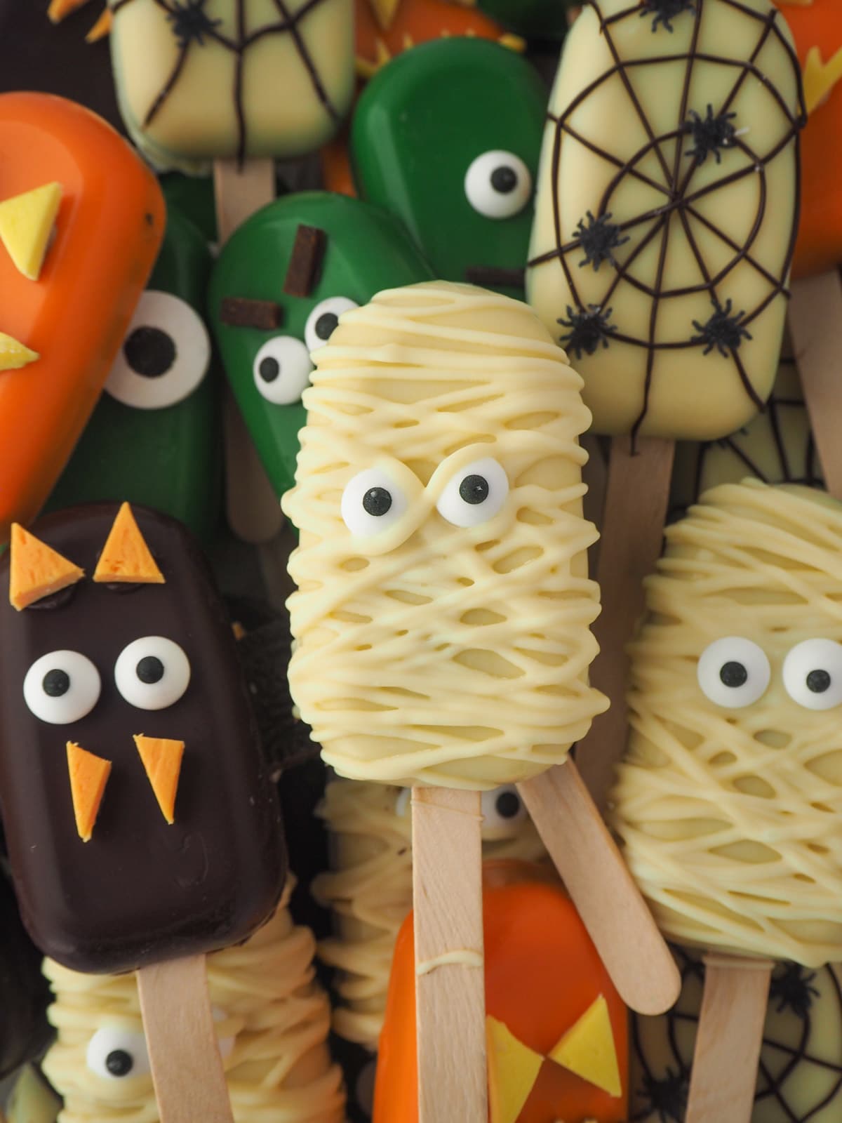 Halloween cakesicles 41 Pile of cakesicles with mummy cakesicle on top.